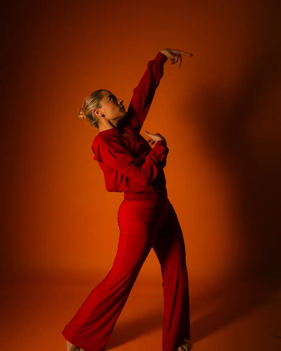 Dancer in red against an orange wall