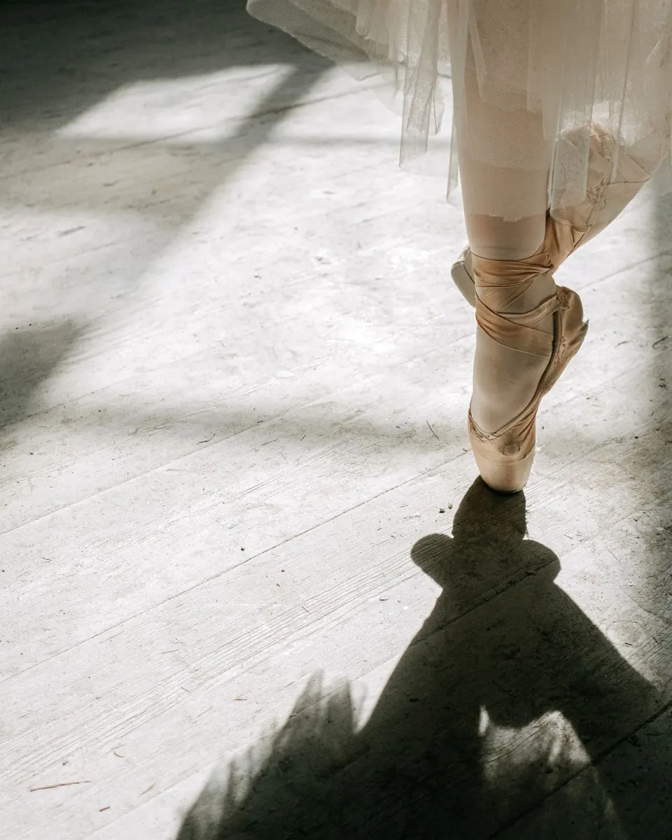 Ballerina on pointe beside her shadow